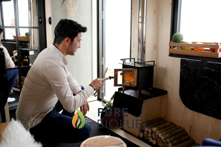Man lighting a stove inside a cozy room