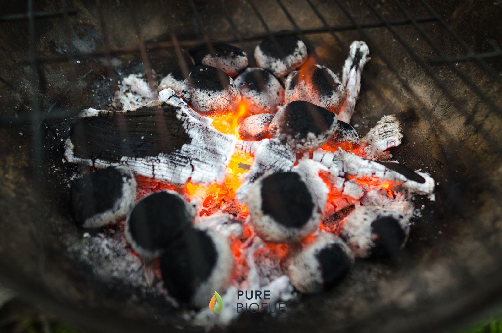 Glowing charcoal briquettes in a barbecue ready for grilling