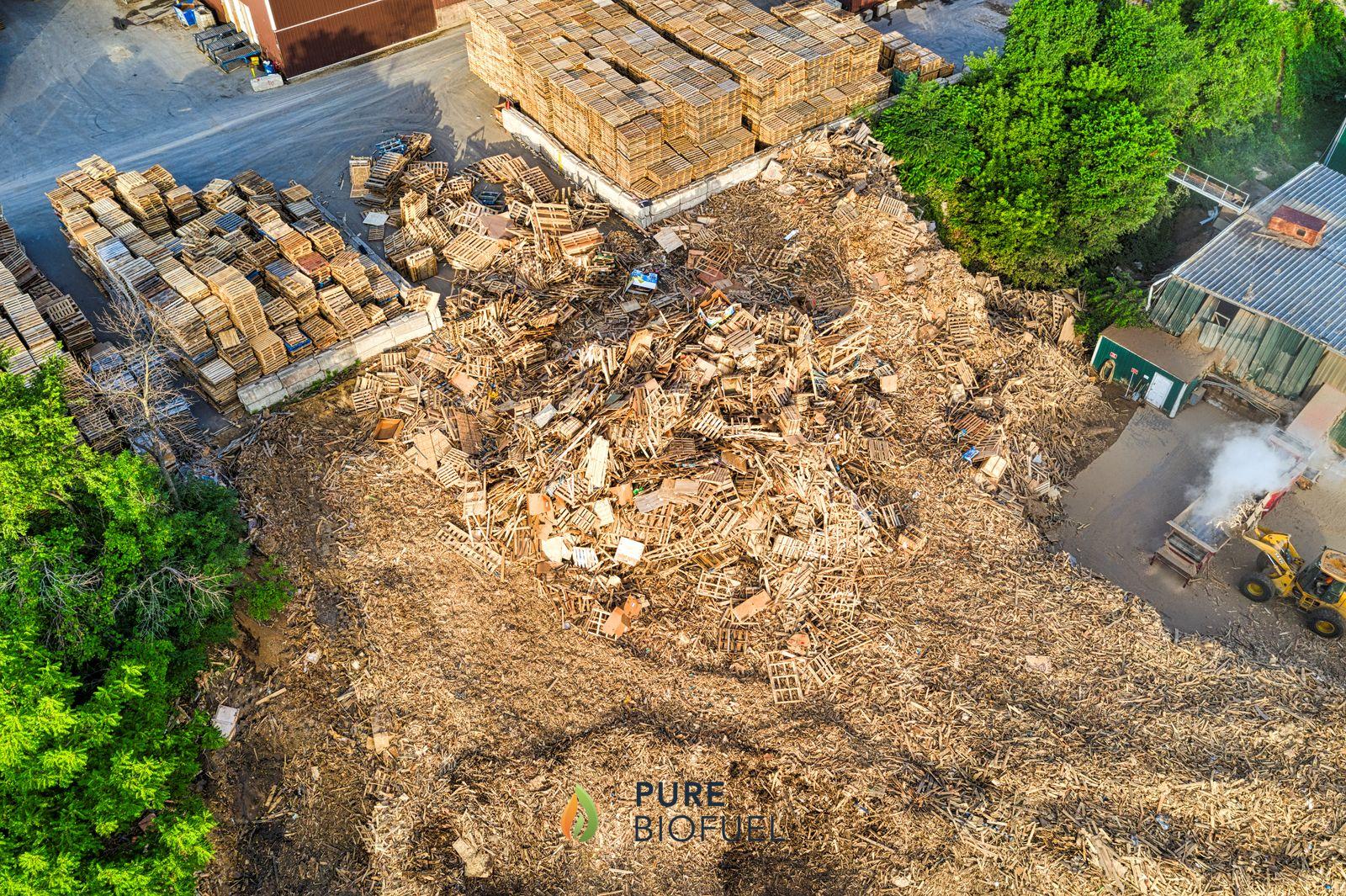 Aerial view of an industrial wood yard with stacked wooden pallets
